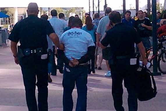 man in cuffs being escorted